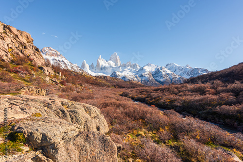 Golden autumn scenery, beautiful snow-capped mountains and blue sky and white clouds. Travel in Argentina.