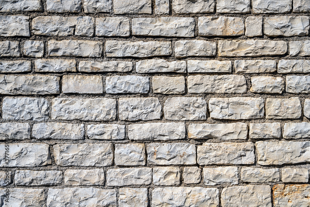 Background from an uniform natural stone wall Background from an uniform natural stone wall