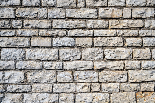 Background from an uniform natural stone wall