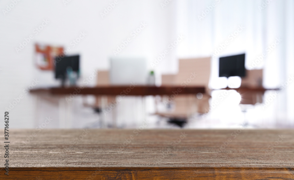 Wooden desk and blurred room on background. Home and office furniture Wooden desk and blurred room on background. Home and office furniture
