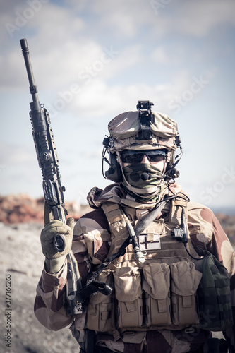 Soldier in a combat situation posing. Men play airsoft.