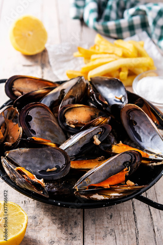Moussels and french fries or molues-frites. Typical Belgian food. 	