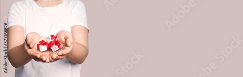 Boxing day, banner design. Woman with gifts on beige background, closeup and space for text