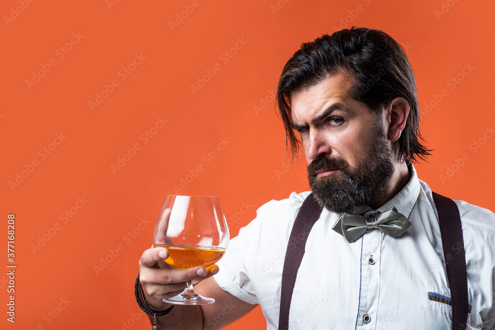 retro man in bow tie relaxing with alcohol. confident elegant bartender in classical wear drinking brandy. masculinity and charisma. whiskey and scotch. old fashioned bearded barman. copy space retro man in bow tie relaxing with alcohol. confident elegant bartender in classical wear drinking brandy. masculinity and charisma. whiskey and scotch. old fashioned bearded barman. copy space