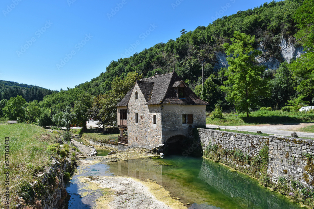 rural house in a mountain landscape with a river
