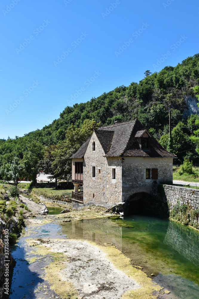 rural house in a mountain landscape with a river
