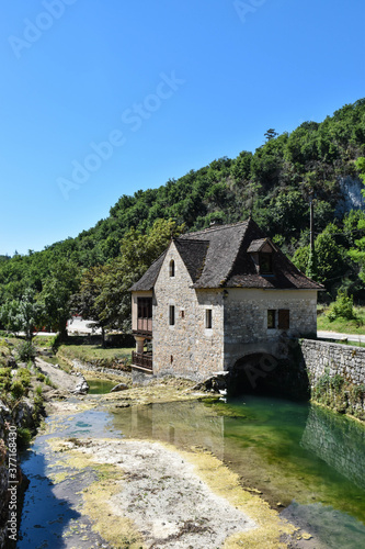 rural house in a mountain landscape with a river 