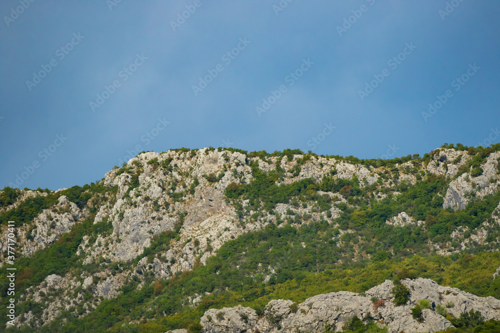 Green rocky mountains on the horizon, montenegro and europe