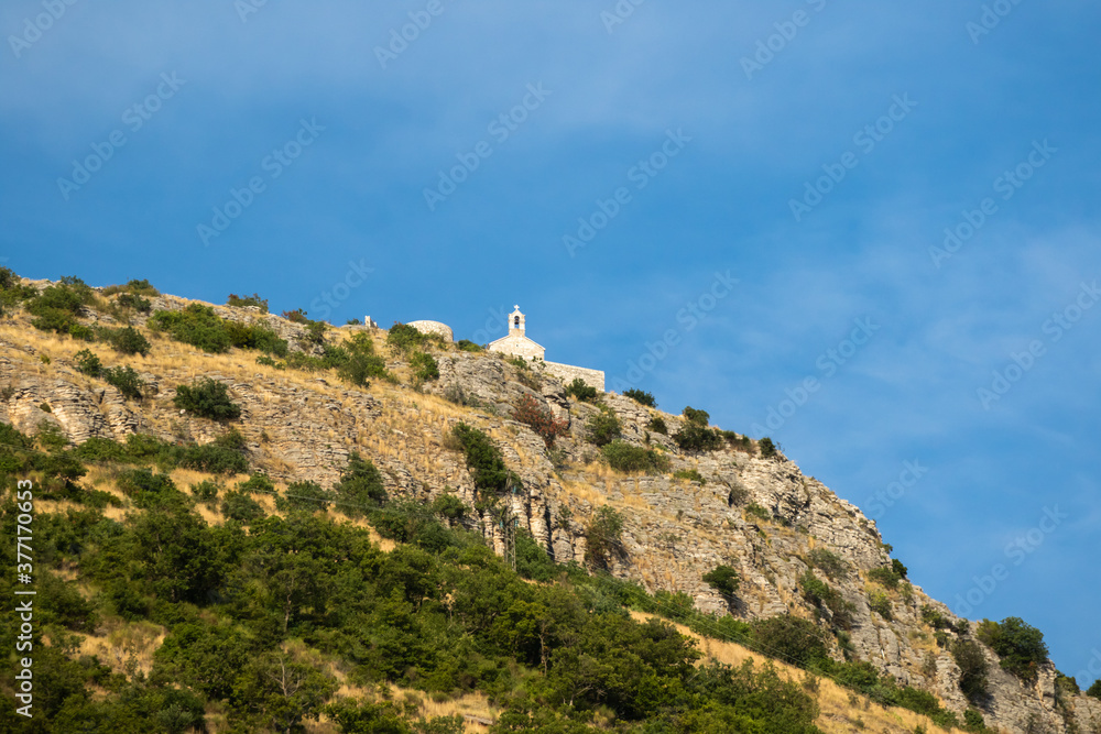 Some kind of shrine and a cross on the mountain, a prayer altar in a hard-to-reach place Some kind of shrine and a cross on the mountain, a prayer altar in a hard-to-reach place