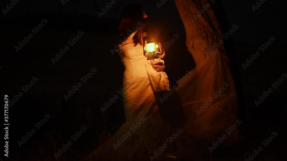 Scary woman with a lantern in night scene - Spooky image of a scary ...