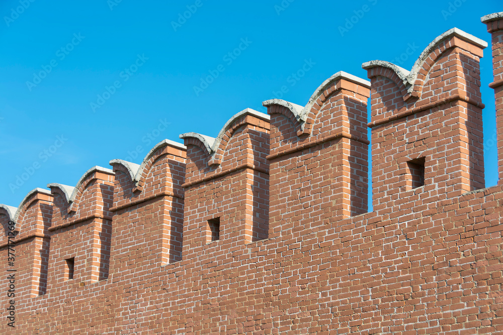 old city red brick fortress wall with windows for shooters
