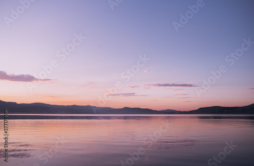 Evening sky at sunset over the lake water surface