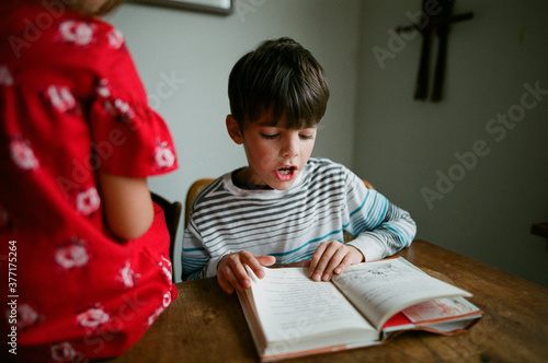 boy reads book aloud