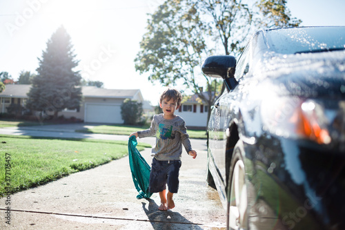 child washed car in driveway