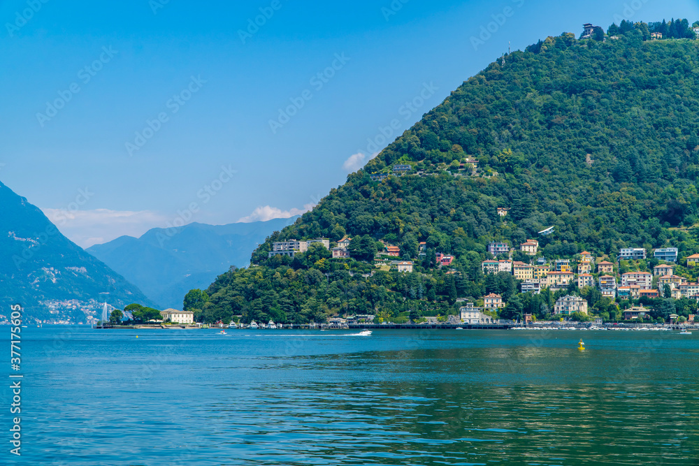 Beautiful view of Lake Como, Italy with fountain, boats, and towns