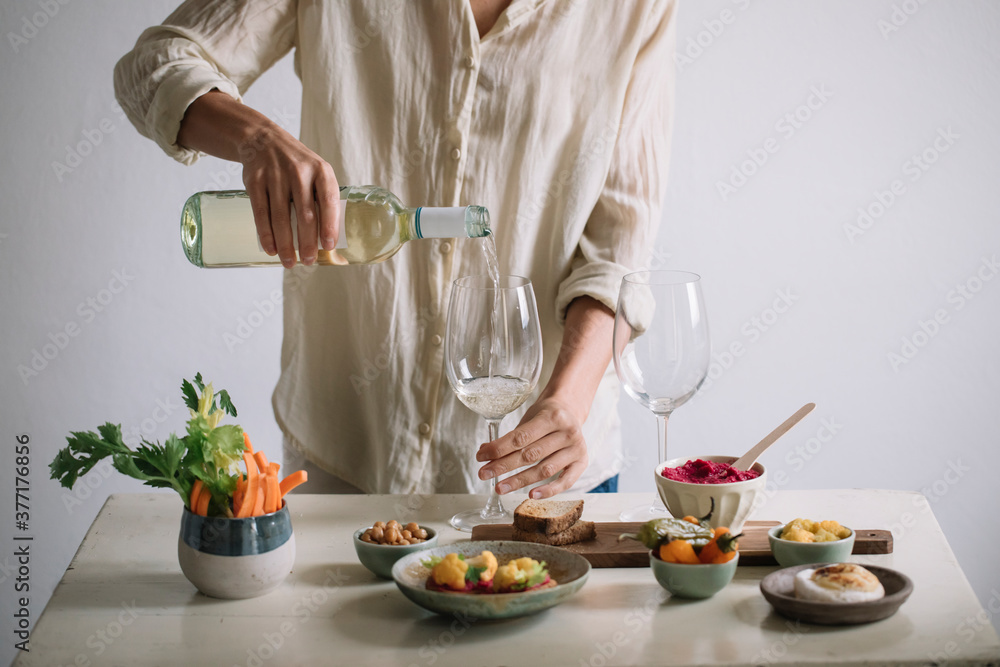 Woman Serving White Wine And Snacks Woman Serving White Wine And Snacks