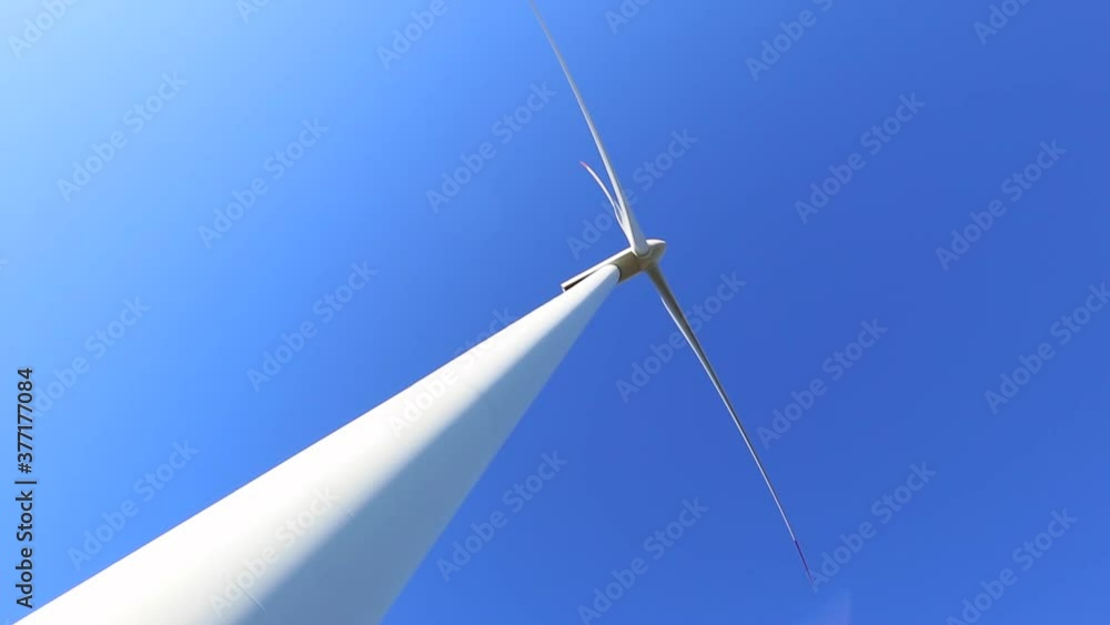 One wind turbine tower, bottom view, energy saving concept. Alternative electricity supply industry, windmill turbine station. One wind turbine tower, bottom view, energy saving concept. Alternative electricity supply industry, windmill turbine station.