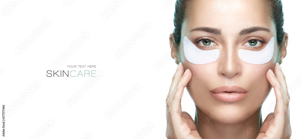Eye care cosmetic mask. Beautiful young woman with healthy fresh skin using patches under eyes.