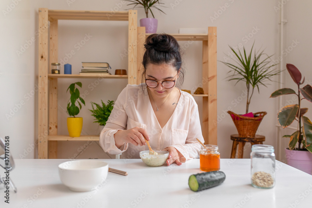 Young woman making a homemade face mask Young woman making a homemade face mask