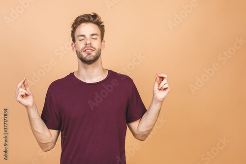 Concentrated relaxed person, standing with closed eyes, having relaxation while meditating, trying to find balance and harmony. Yoga and meditation concept.