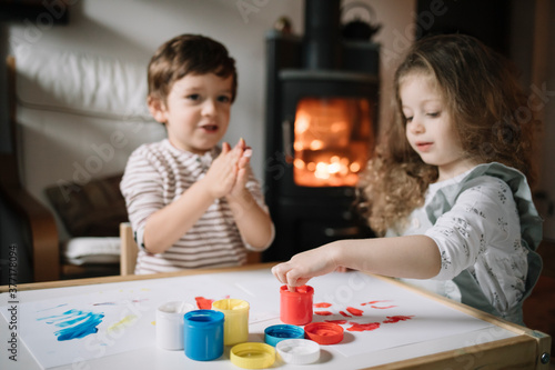 Young kids painting with their hands photo