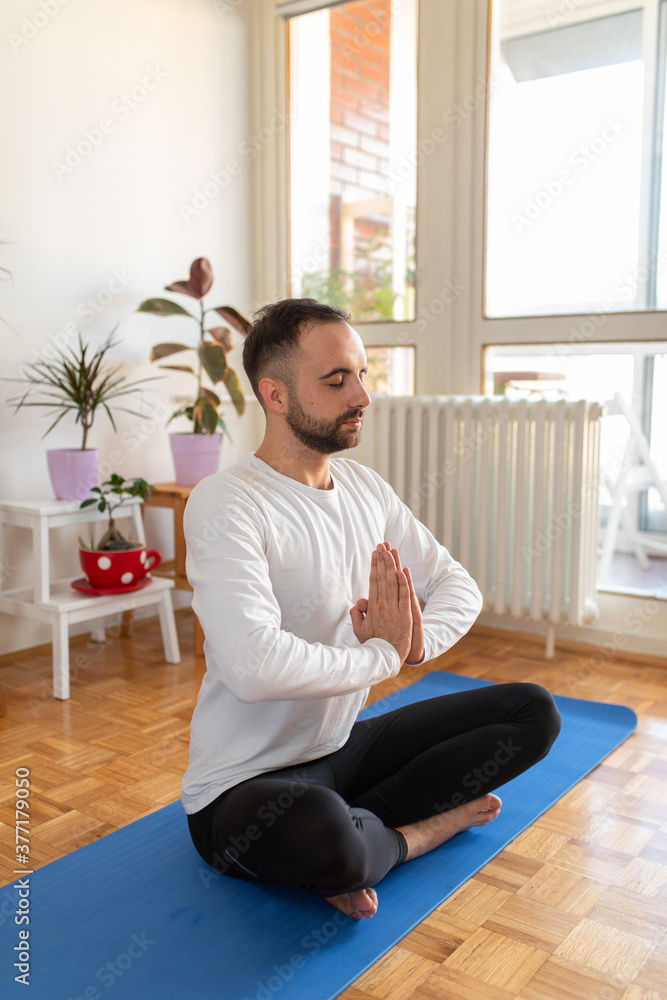 Young man doing yoga at home Young man doing yoga at home