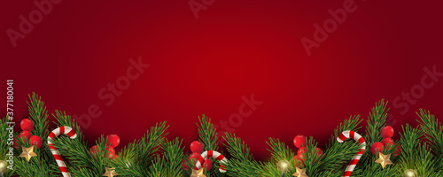 Merry Christmas and Happy New Year. Christmas banner design of tree branches with berries, gold stars, candy canes and decorated in red background. 