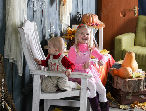 two sisters on a chair in halloween decorations