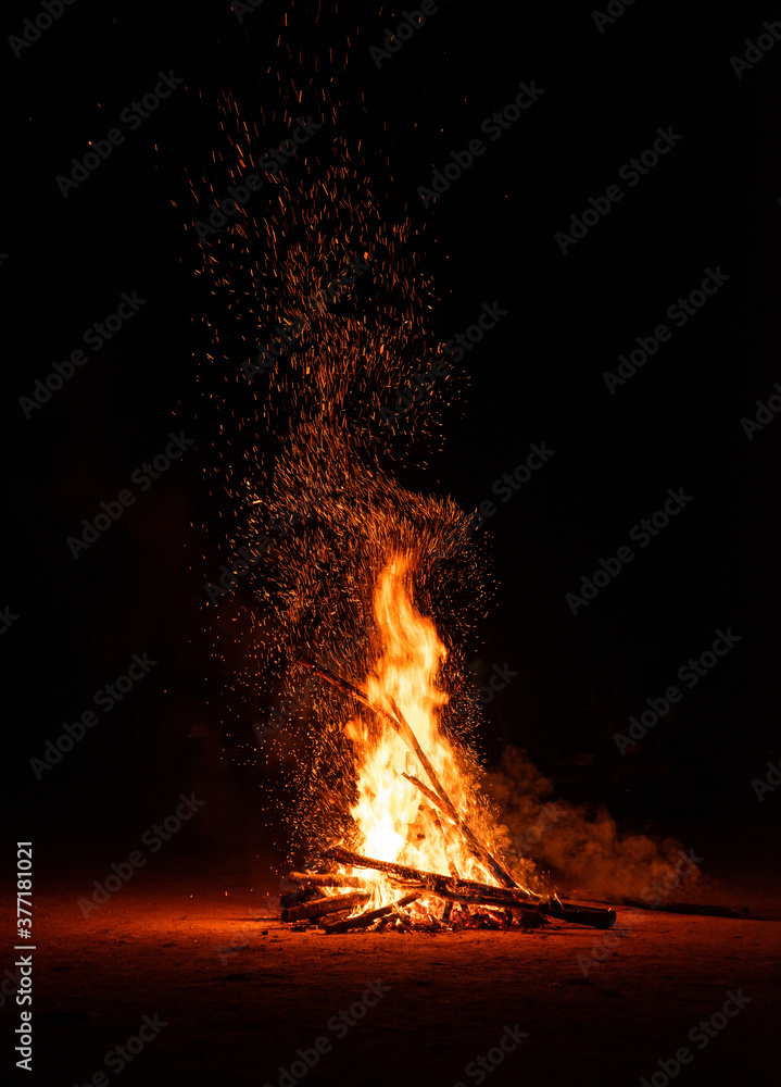 Camp fire in the night. Burning wood at night. Campfire at touristic camp at nature in dark. Flame amd fire sparks on black background. Hellish fire element. Fuel, power and energy Camp fire in the night. Burning wood at night. Campfire at touristic camp at nature in dark. Flame amd fire sparks on black background. Hellish fire element. Fuel, power and energy