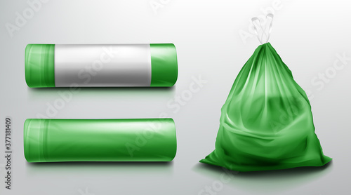 Trash bag mockup, plastic roll and sack full of garbage. Green disposable package for rubbish mock up. Household supplies for waste throw isolated on grey background. Realistic 3d vector illustration