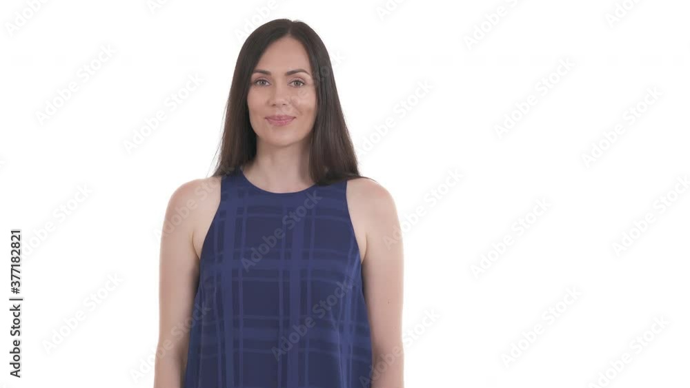 Portrait of young Caucasian woman pointing to the right with approval nodding. Empty space for advertisement. Isolated on white background Portrait of young Caucasian woman pointing to the right with approval nodding. Empty space for advertisement. Isolated on white background