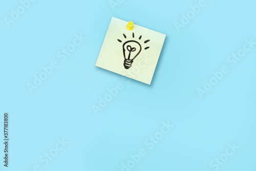 drawing of light bulb on post paper , idea board concept