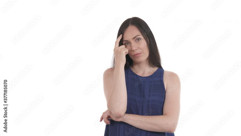 Portrait of pensive Caucasian woman tapping forefinger on temple and looking at camera. Isolated on white background. Portrait of pensive Caucasian woman tapping forefinger on temple and looking at camera. Isolated on white background.
