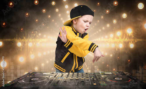 The little boy in the style of Hip-Hop .Cool rap dj. Children's fashion.Cap and jacket.DJ.