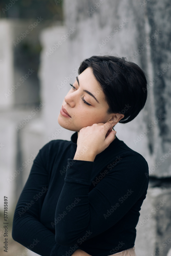 Portrait Of Young Woman Posing On Concrete Background Portrait Of Young Woman Posing On Concrete Background