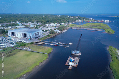 Southport marina destroyed after hurricane Isaias. All the docks are missing and a barge is set up to repair the damage.