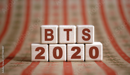 BTS 2020 text on wooden cubes on a monochrome background with reflection. photo