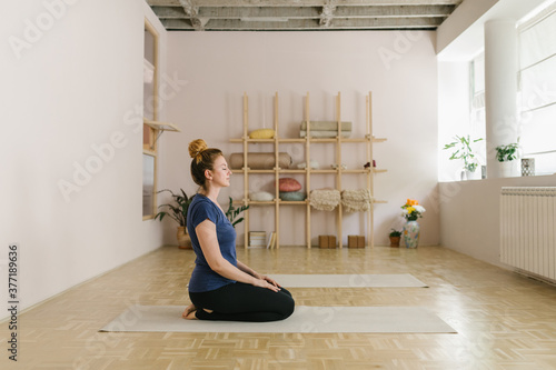 Two adult women practice yoga in a yoga studio photo