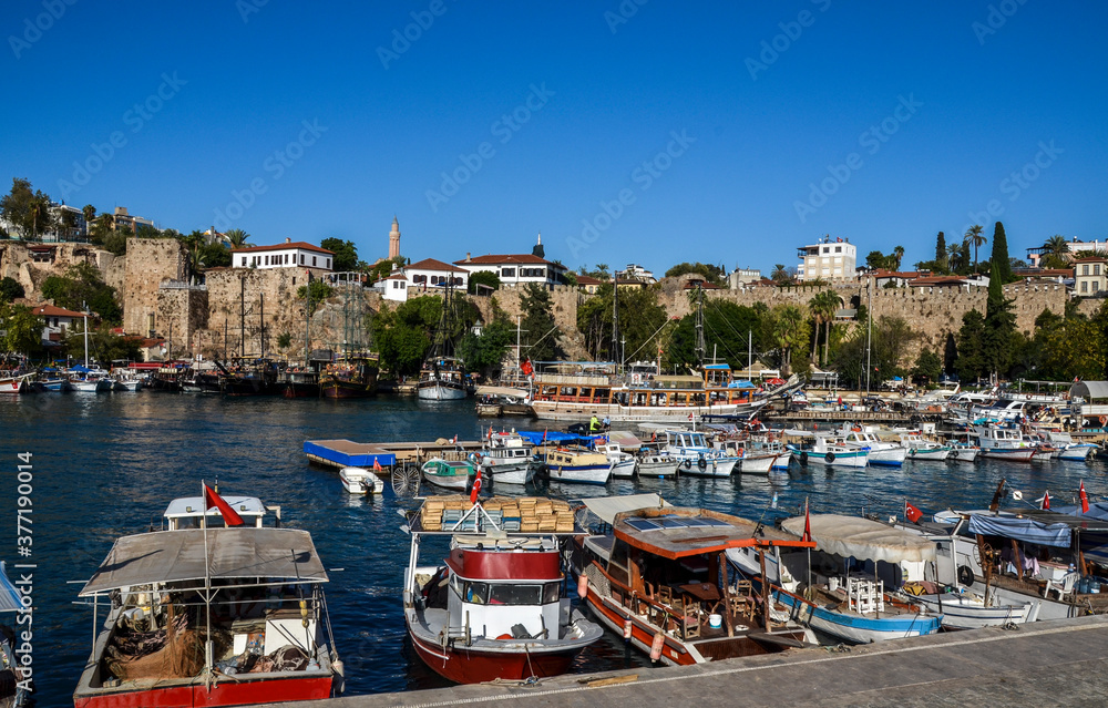 View of boats yachts and tourist galleons moored in old marina or port harbor Kaleici at Mediterranean sea. Antalya, Turkey 