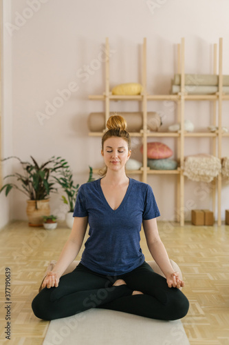 Woman practice yoga in a yoga studio photo