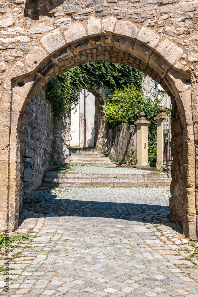 Obraz premium A gate made of stones near the church