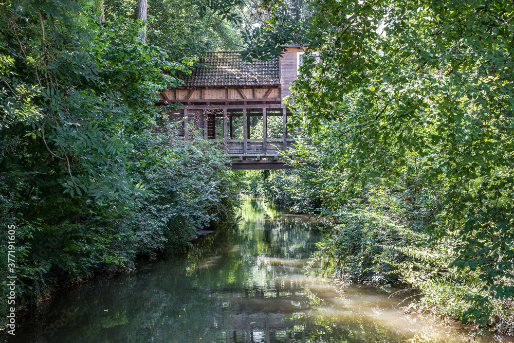 Little wooden bridge across the dirty brown river Little wooden bridge across the dirty brown river