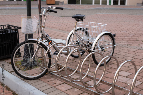 Gorki Gorod, Sochi, Russia . 09.07.2020 : silver large adult tricycle with basket in the parking lot for bicycles
