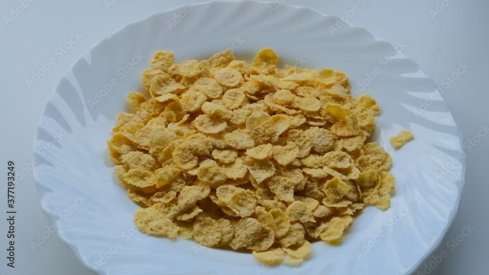 cornflakes slowly fall into the plate cornflakes slowly fall into the plate