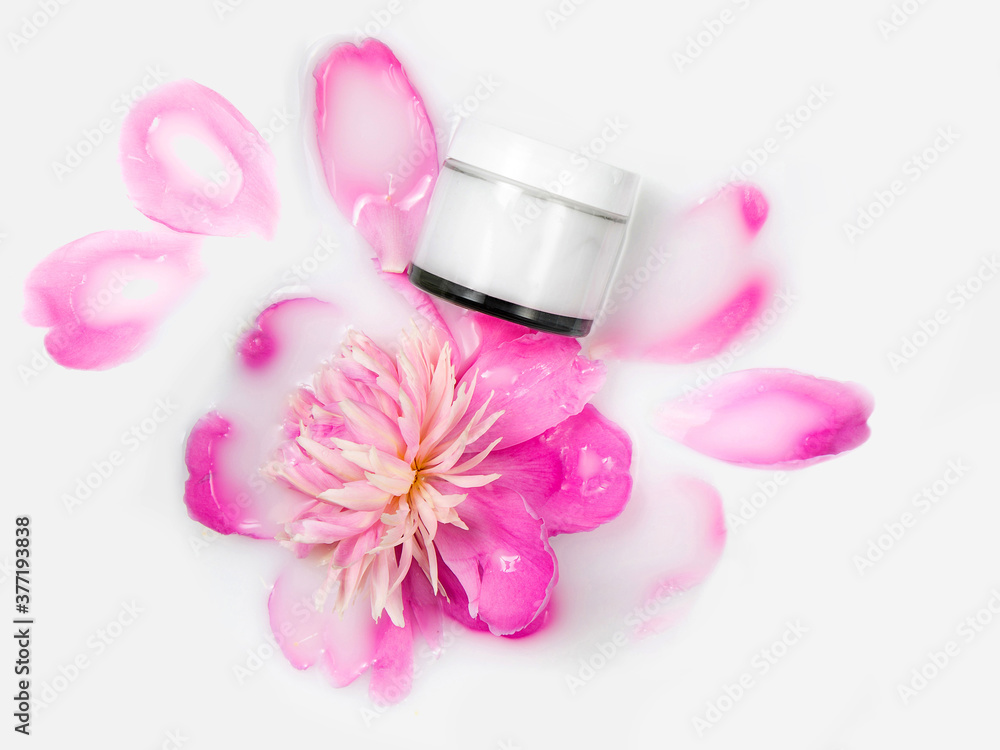 Cream and peony flower in a bath with milk. Gentle care. Conceptual photo: the best cosmetic tool for body and face care. Natural cosmetics, mock up. Cream and peony flower in a bath with milk. Gentle care. Conceptual photo: the best cosmetic tool for body and face care. Natural cosmetics, mock up.