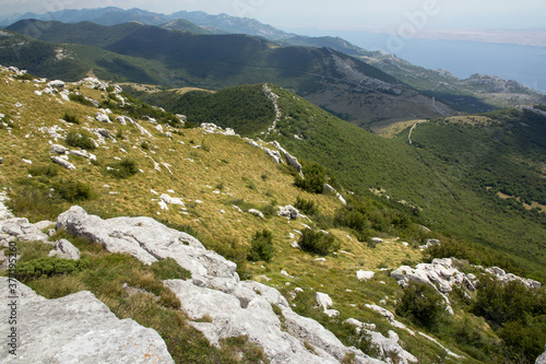 Hiking Velebit mountain in Croatia in summer, Velebit peaks Visibaba Kiza, Bacic kuk mountain rocks at Dabarski kukovi photo