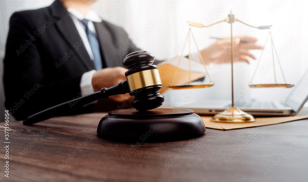 justice and law concept.Male judge in a courtroom on wooden table and Counselor or Male lawyer working in office. Legal law, advice and justice concept. justice and law concept.Male judge in a courtroom on wooden table and Counselor or Male lawyer working in office. Legal law, advice and justice concept.