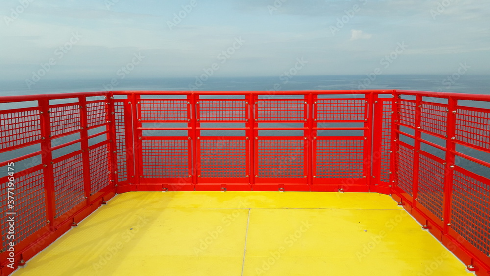 Wind turbine nacelle offshore helipad with yellow and red colors and empty background