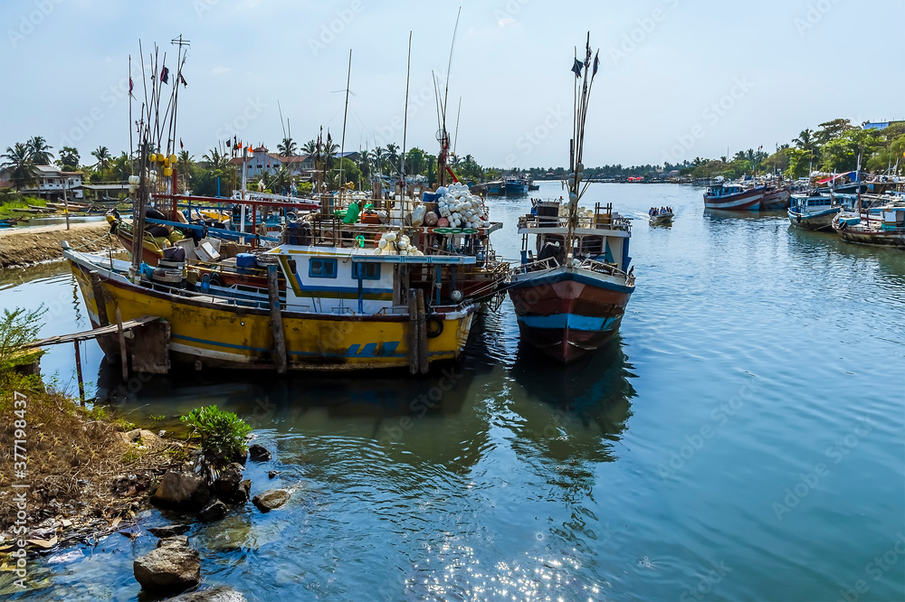 A view of fishing vessels across the entrance to the lagoon in Negombo, Sri Lanka