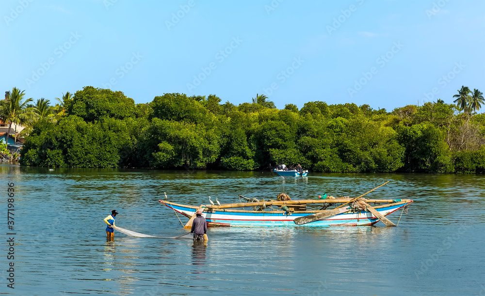 Fototapeta premium A view of fishermen landing their catch in the lagoon in Negombo, Sri Lanka